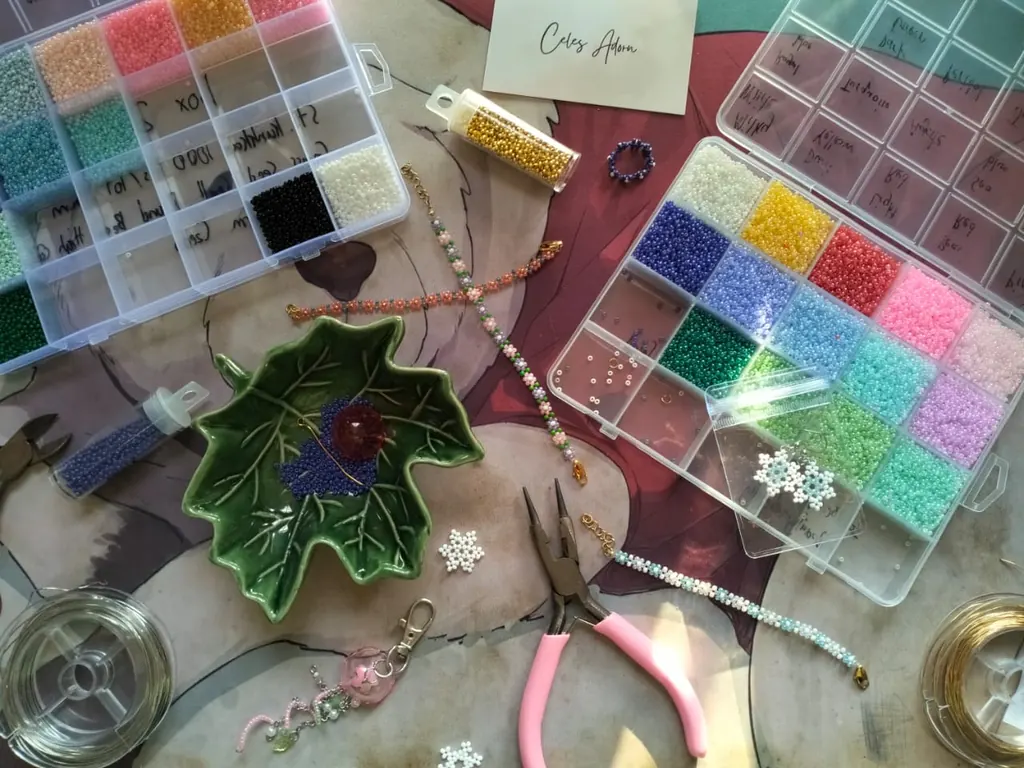 The work table: trays of glass seed beads sorted by colour, pliers and a half-finished piece